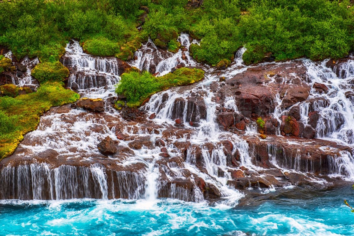 Hraunfossar series of waterfalls formed by rivulets streaming over a distance of about 900 metres. Iceland travel destination