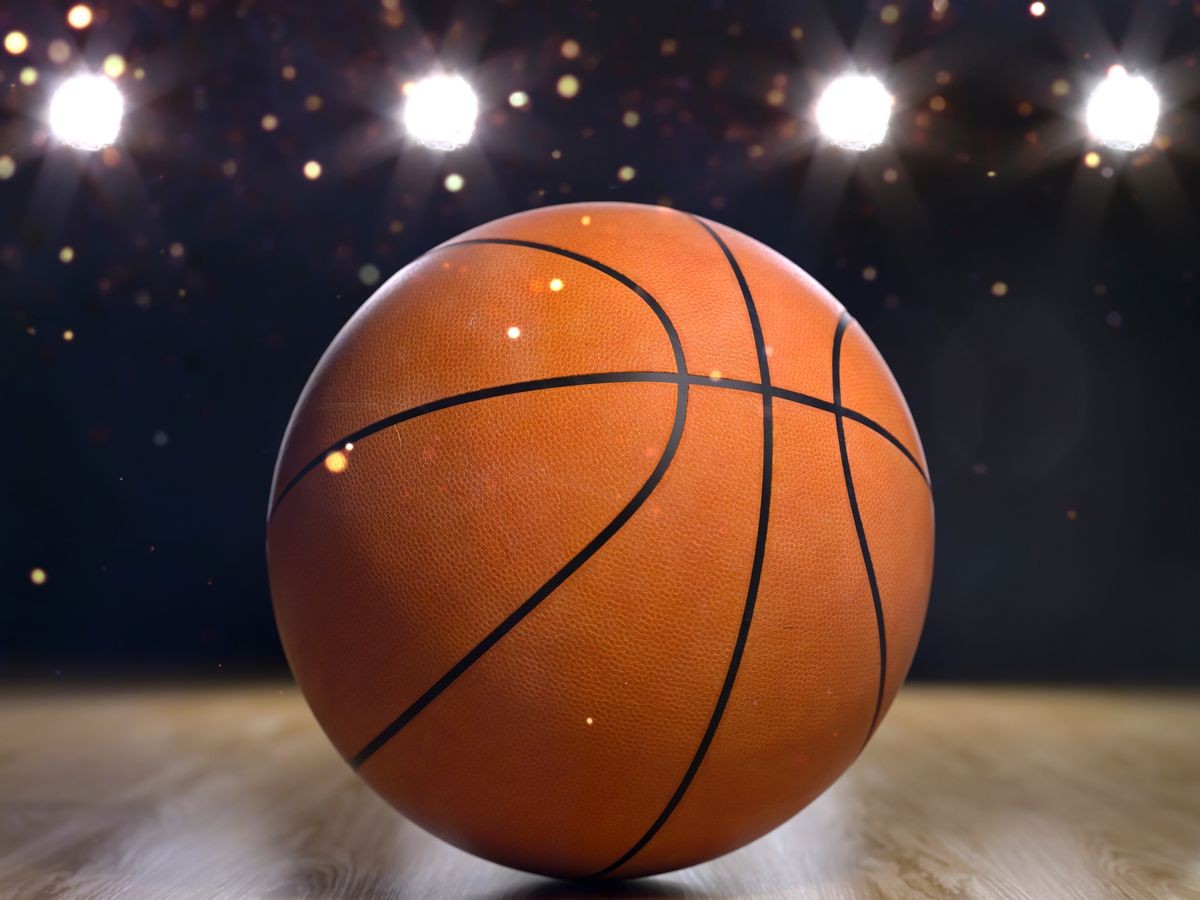 Basketball close-up on black background with bokeh, spotlights