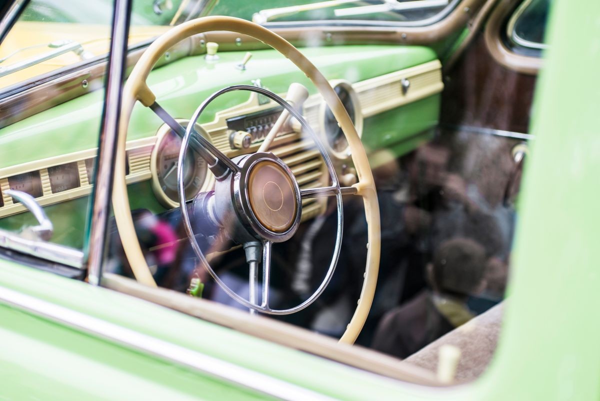 Retro steering wheel in old car. Interior of classic vintage car