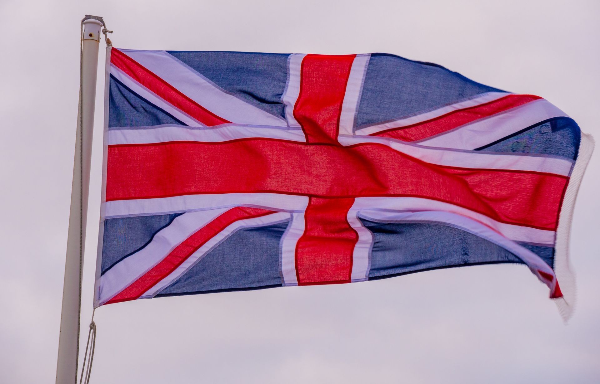 British flag waving in the wind at the Cornish Coast