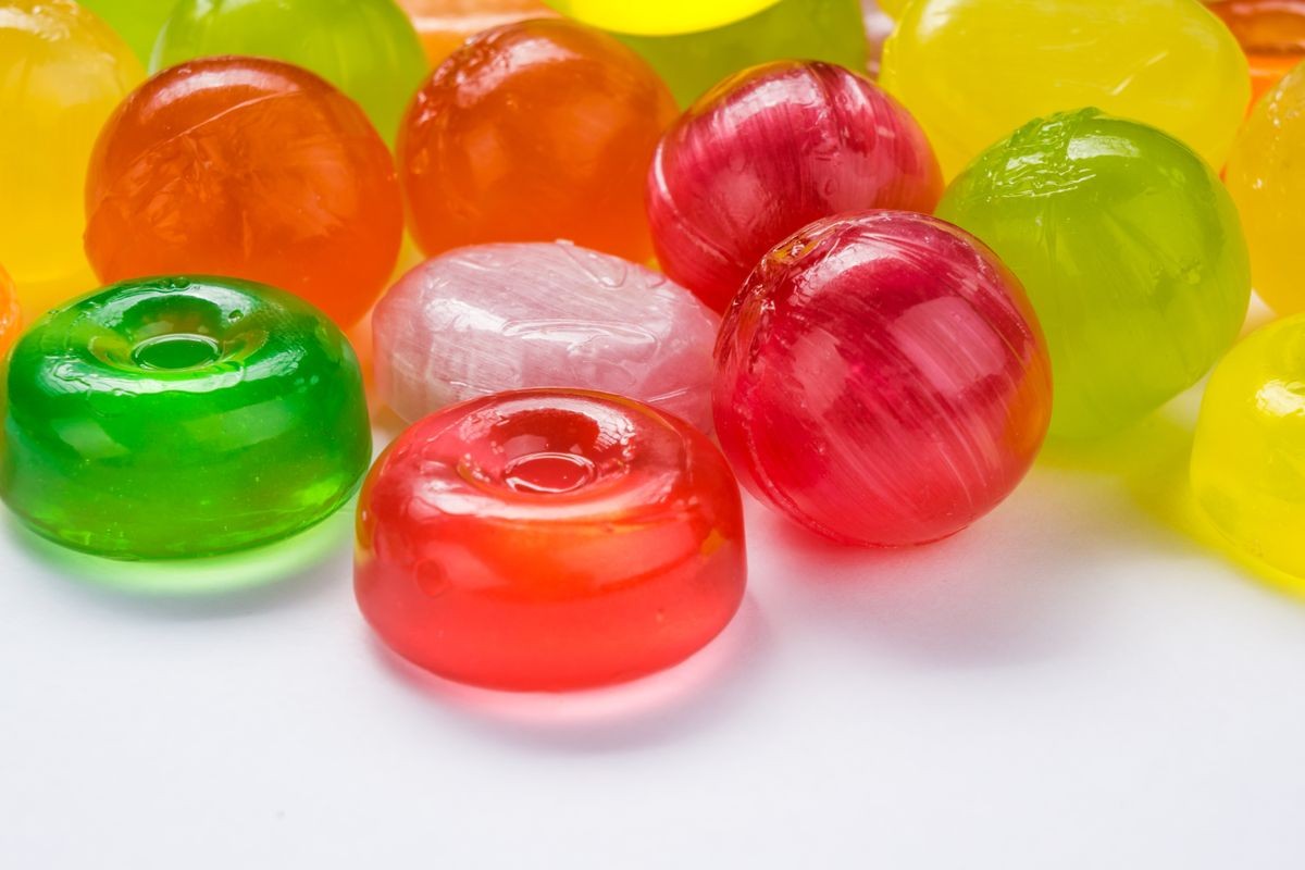 Beautiful colorful and delicious candy sweets and jelly marshmallows. different shapes and composition lollipops and marmalade isolated on abstract blurred white background. Detailed closeup shoot.