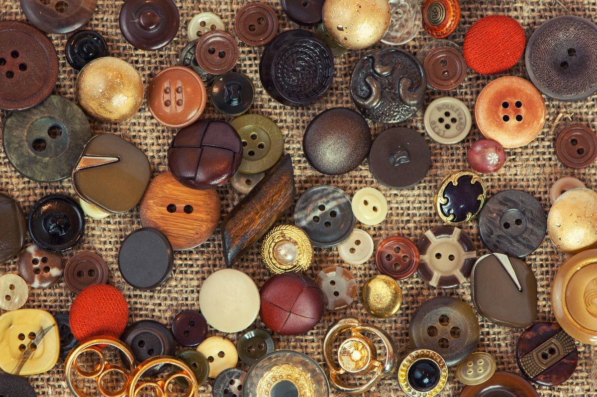 A Colorful button on burlap texture for background.