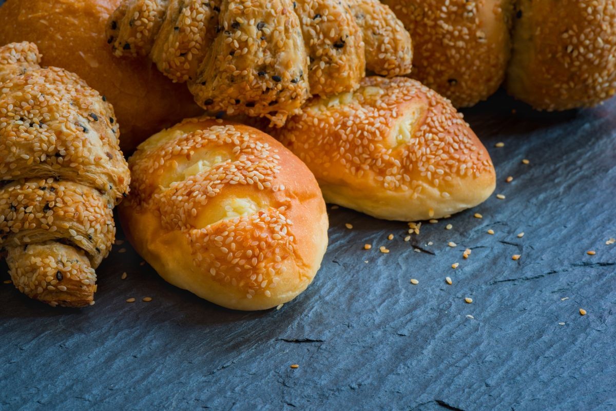 Traditional homemade bakery bread with sesame, Stack of fresh bread on stone table
Closeup traditional homemade bakery bread with sesame
