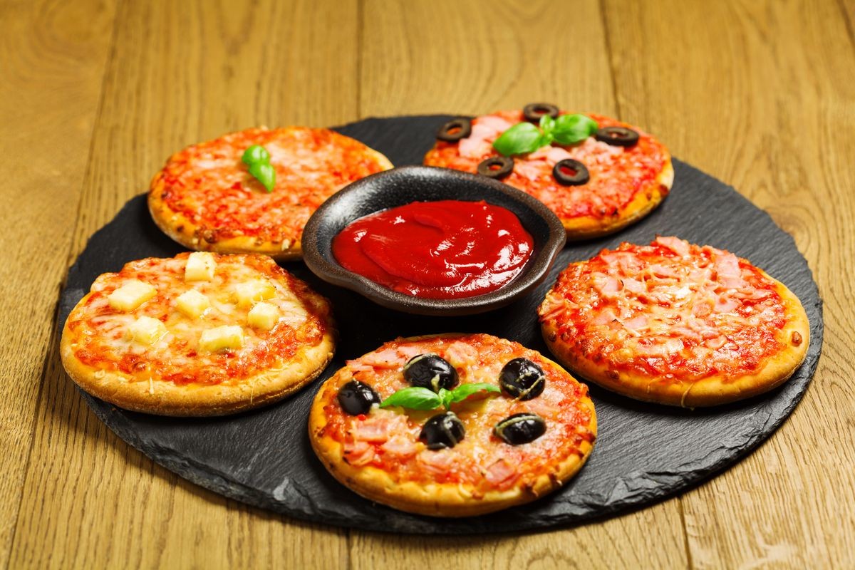 Mix of mini pizzas on a stone try