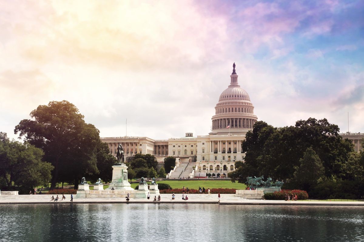 United States Capitol Building as seen across the reflecting water pool at Washington, DC. With beautyful clouds sky, Soft blurry focus.