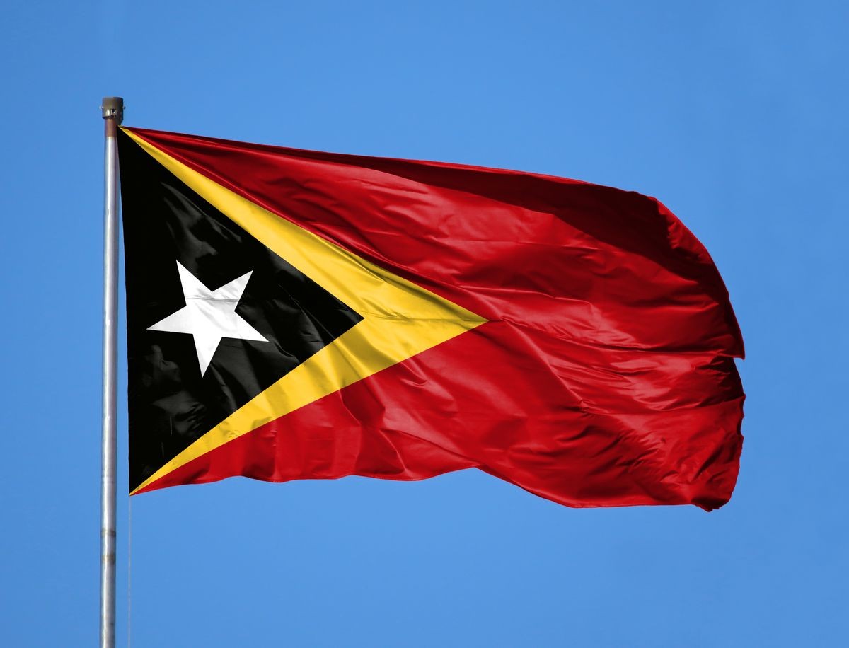 National flag of East Timor on a flagpole