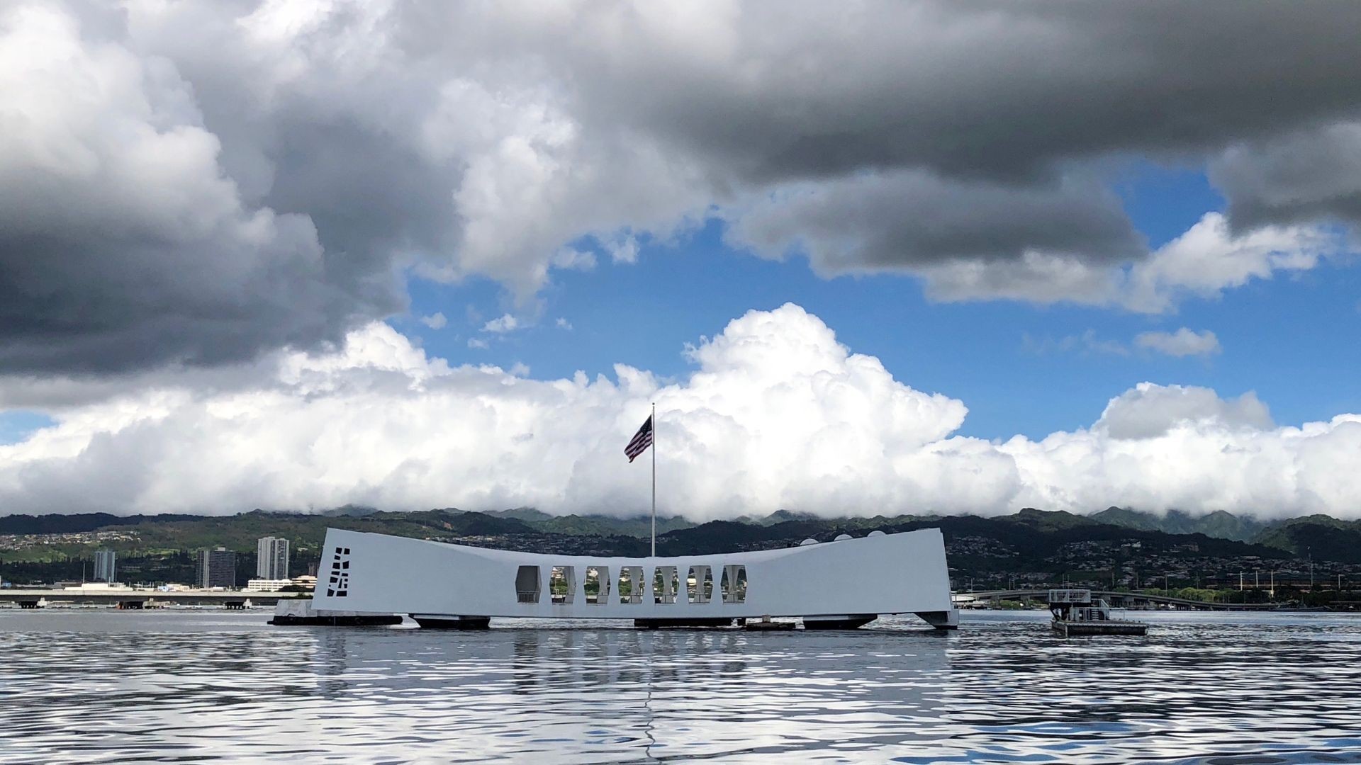 Blue sky with dark clouds around USS Arizona Memorial in Pearl Harbor in Hawaii, USA