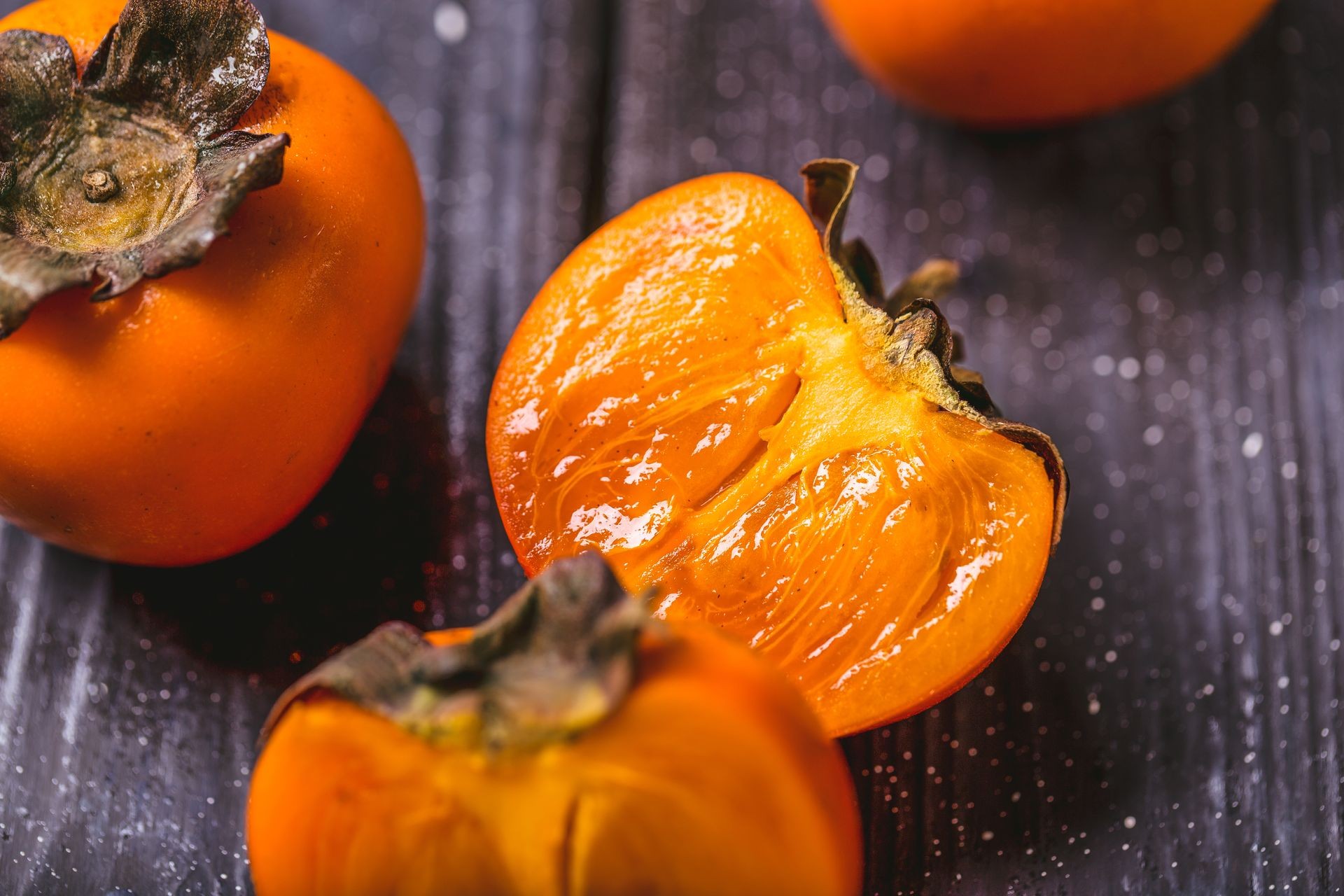 persimon at black background fruits orange