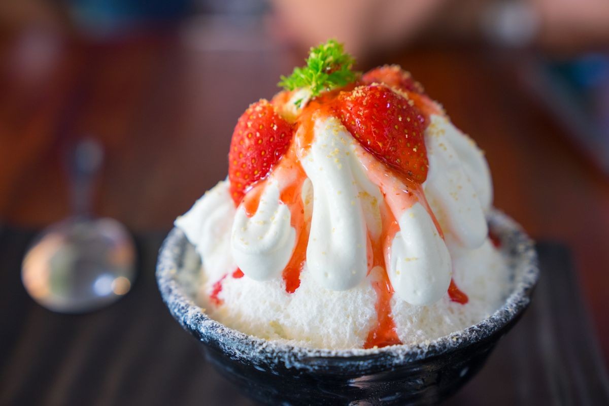 Close up Strawberry bingsu dessert on table in modern cafe, Korea style.