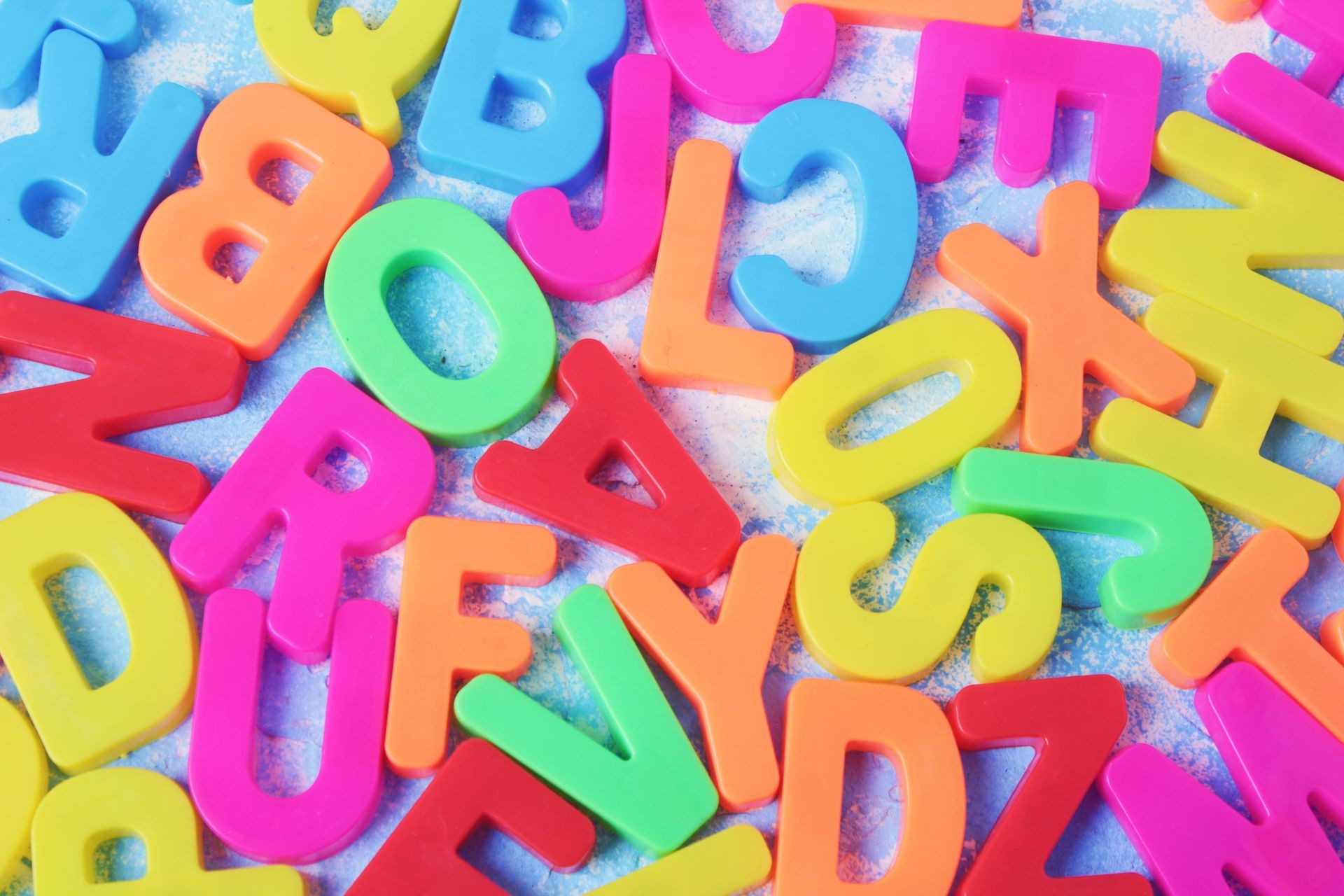 Colorful magnetic letters on a blue background.alphabet  background.
back to school