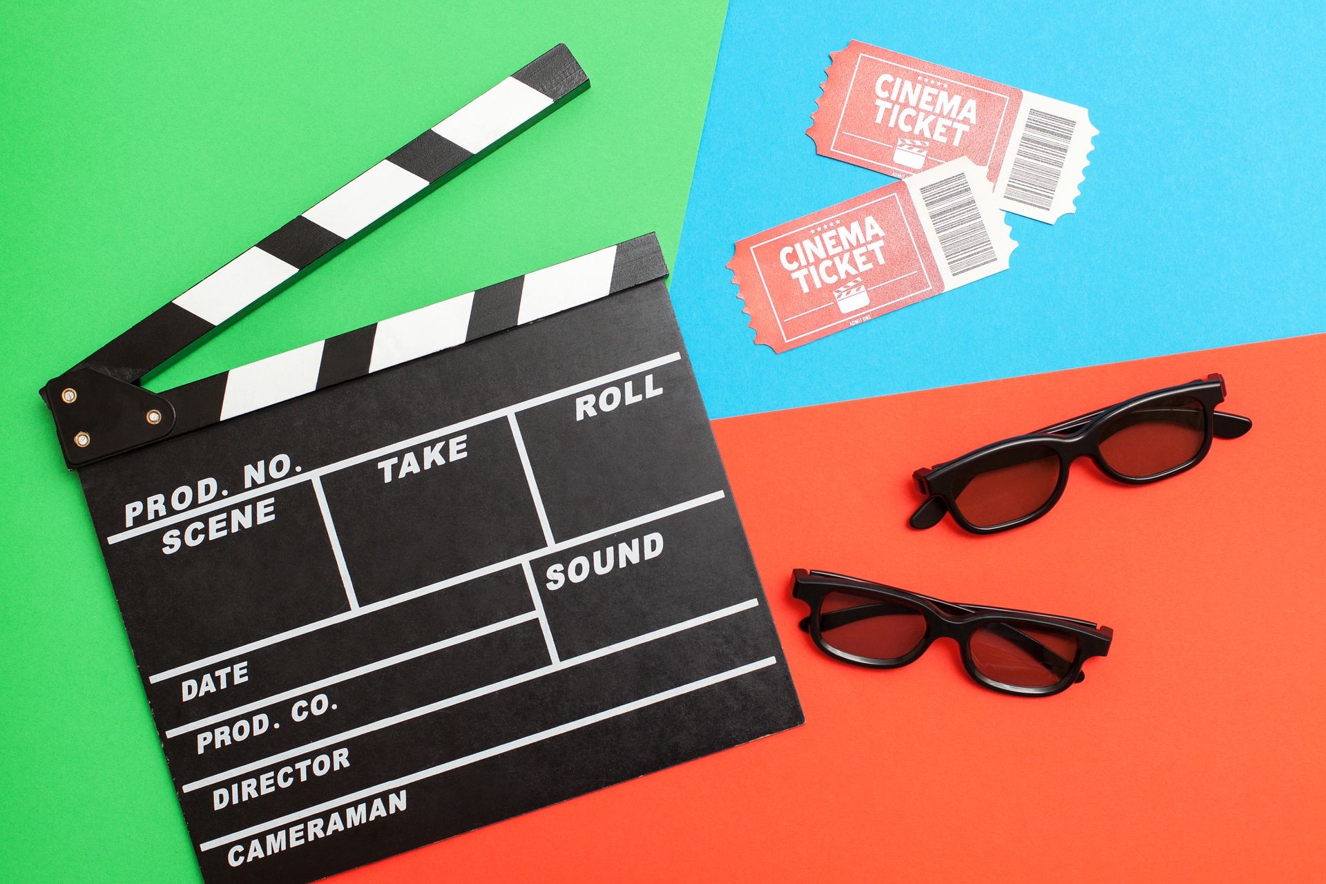 Movie time, flat lay. Cinema minimal concept. Composition on a red-green-blue background with a movie, 3D glasses and movie tickets