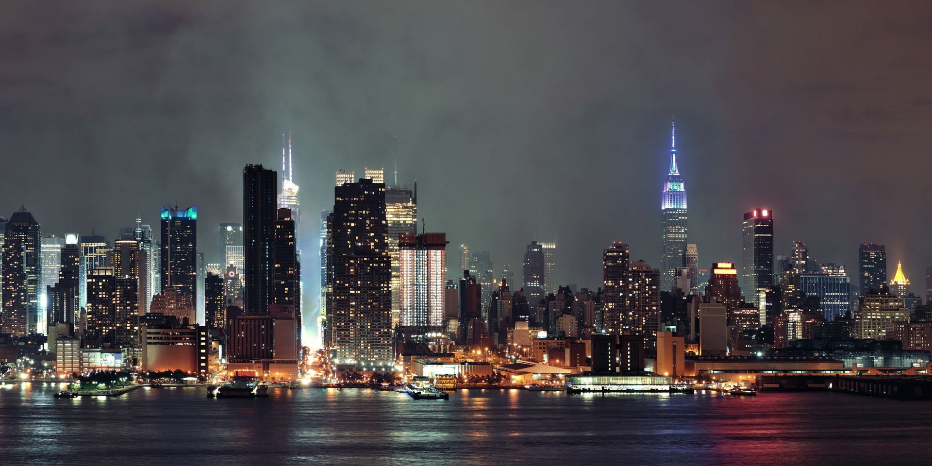 Manhattan midtown skyscrapers and New York City skyline panorama at night with fog