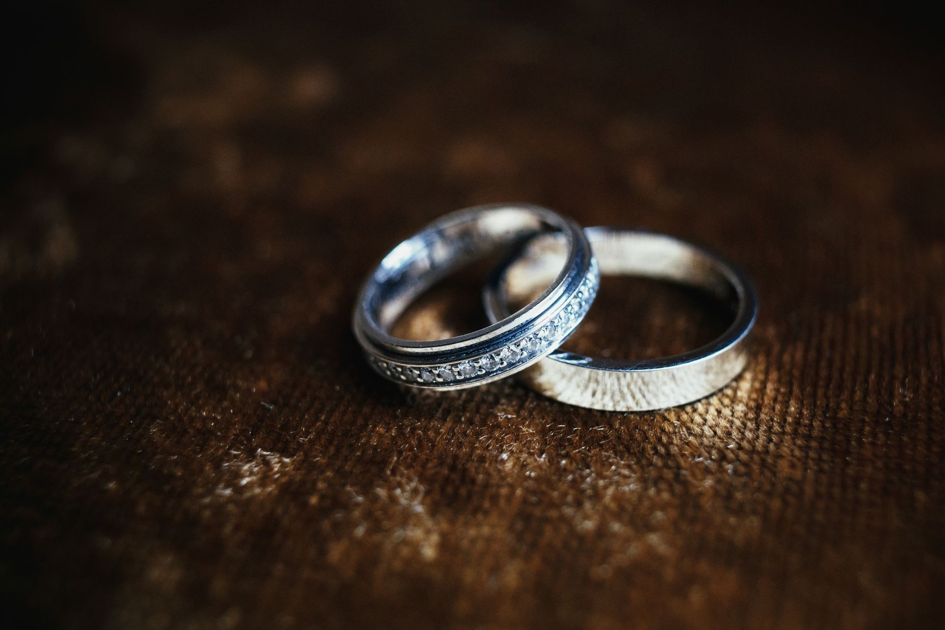 Golden wedding rings lie on brown chair