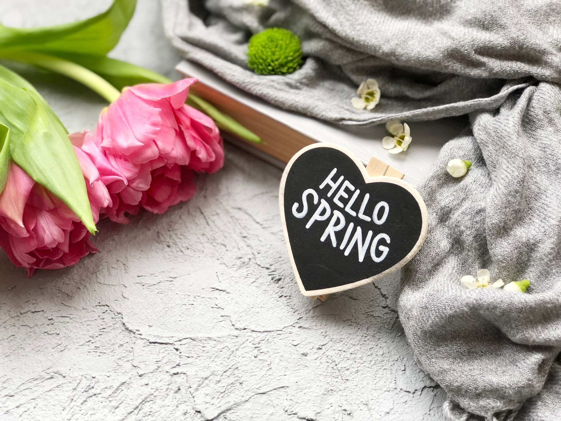 hello spring. chalkboard with hello spring text and smile with tulips