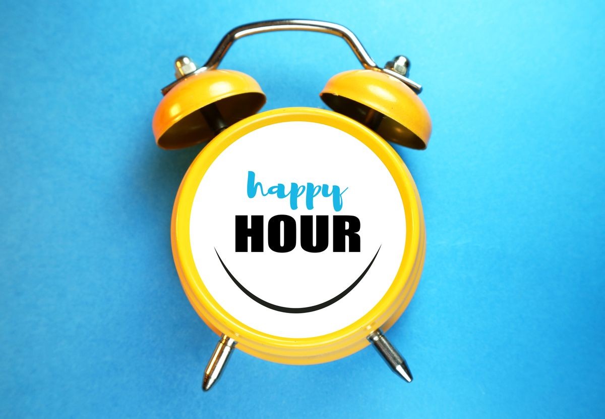 Happy hour concept. Alarm clock smiling and text.