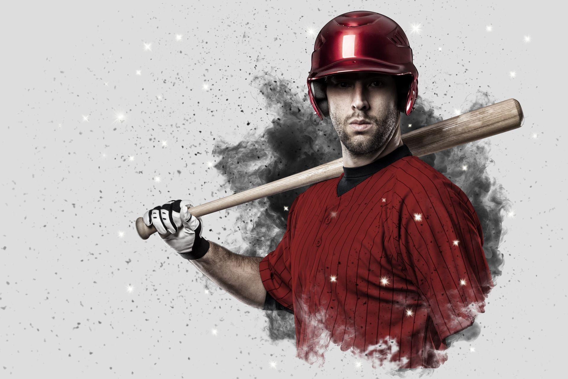 Baseball Player with a red uniform coming out of a blast of smoke .