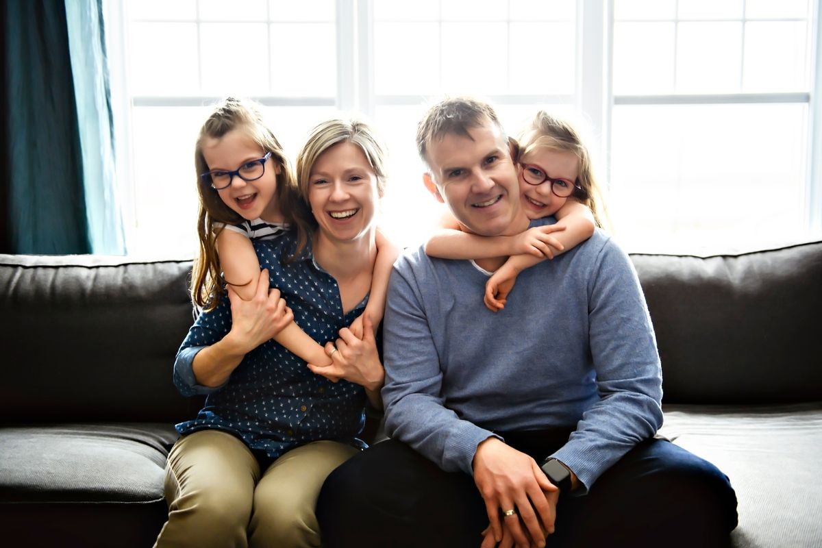 A Portrait of nice cute cheerful family parent with the twin girls