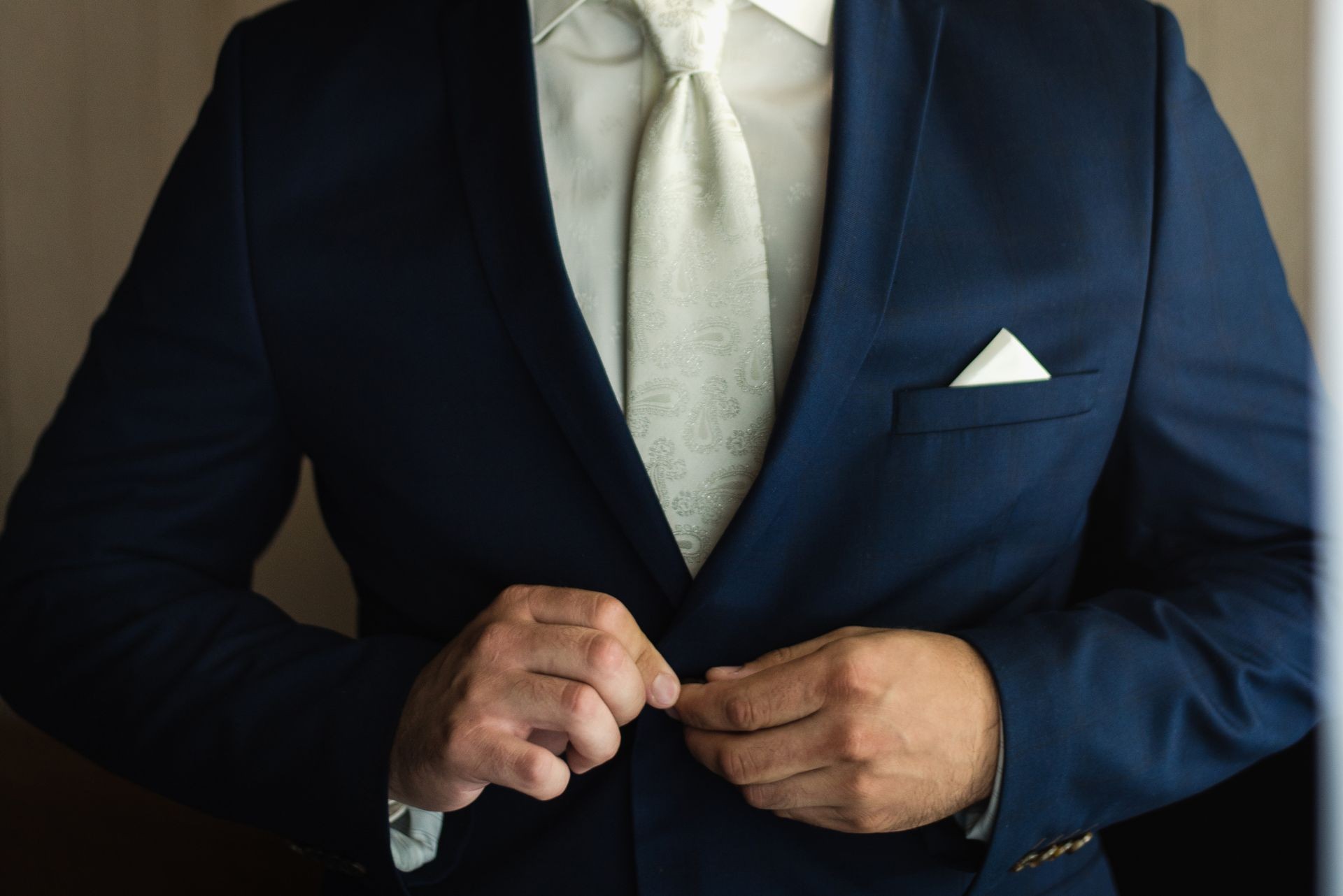 the man zips up his jacket, groom in a jacket, white tie, bridegroom's fees, business style