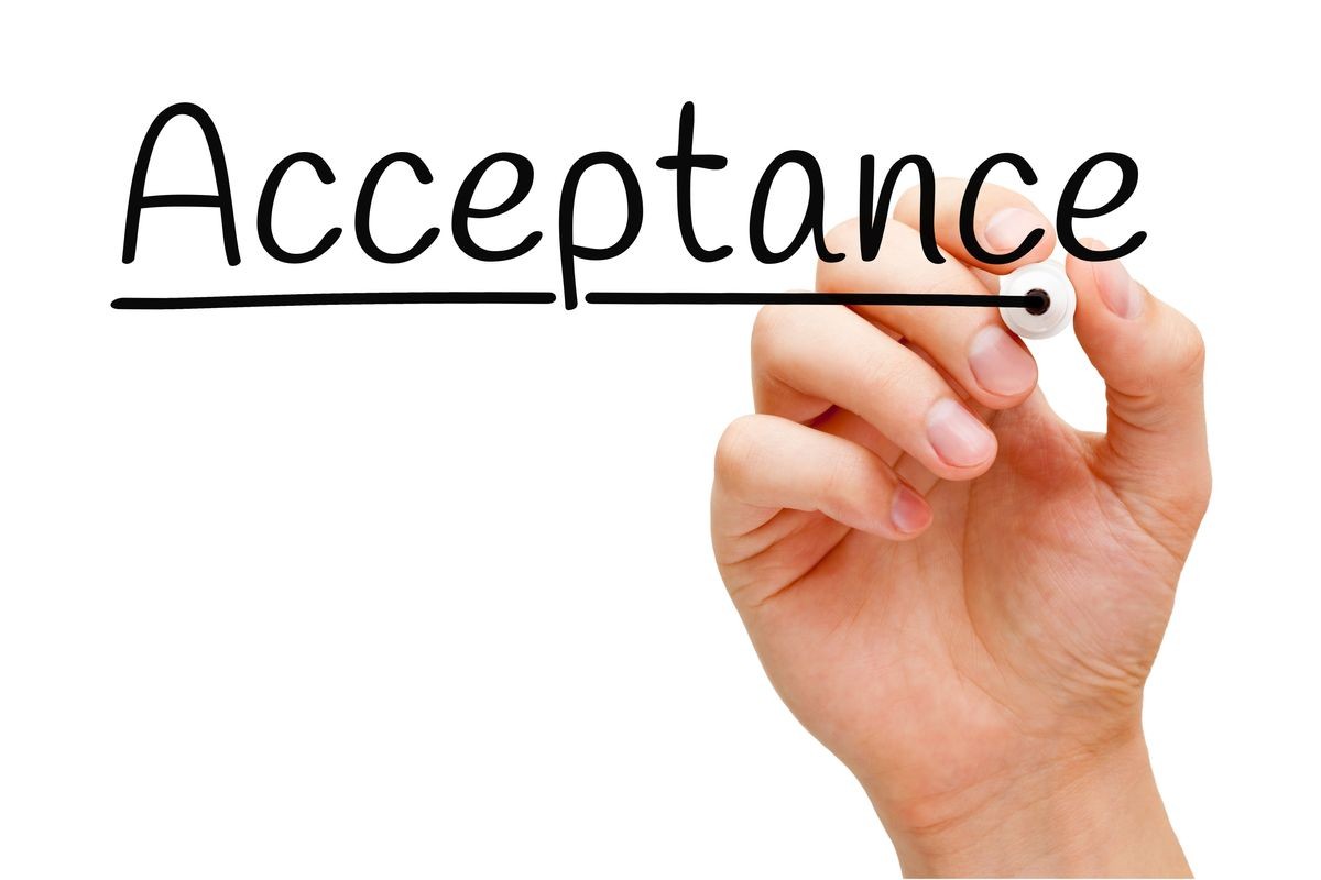 Hand writing Acceptance with black marker on transparent wipe board isolated on white.