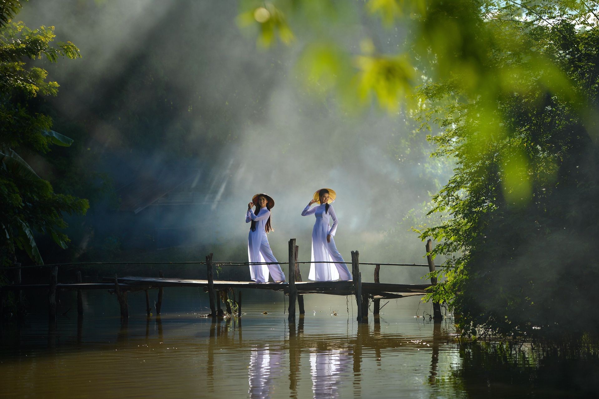 Beautiful  woman with Vietnam culture traditional dress on during sunset,Vietnam