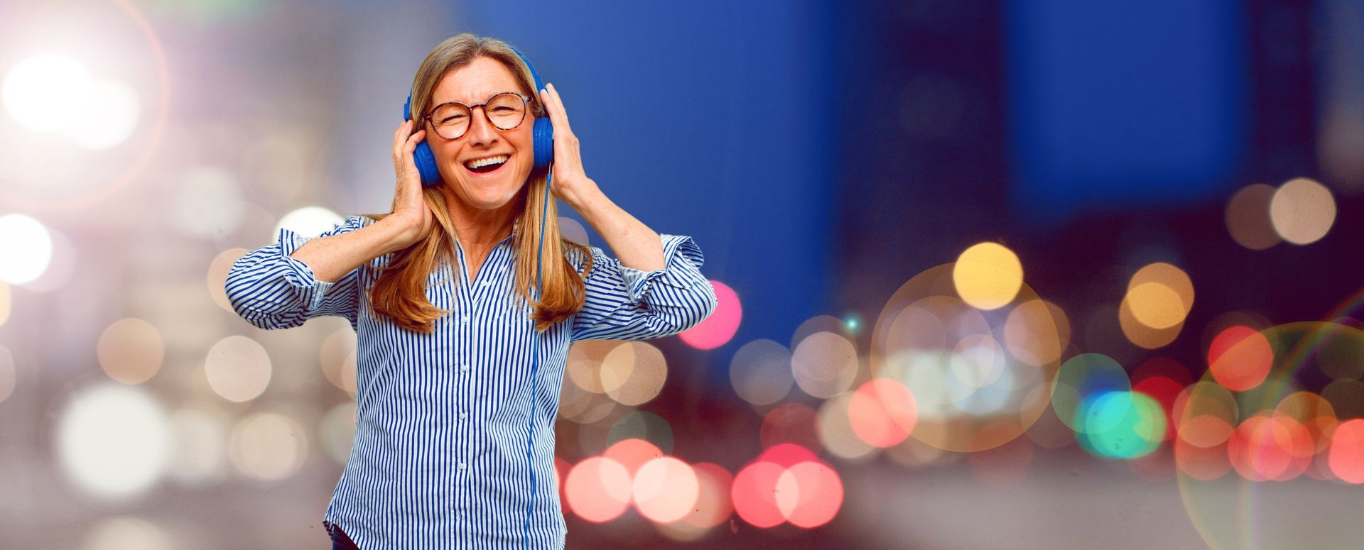 senior beautiful woman listening music with a headphones