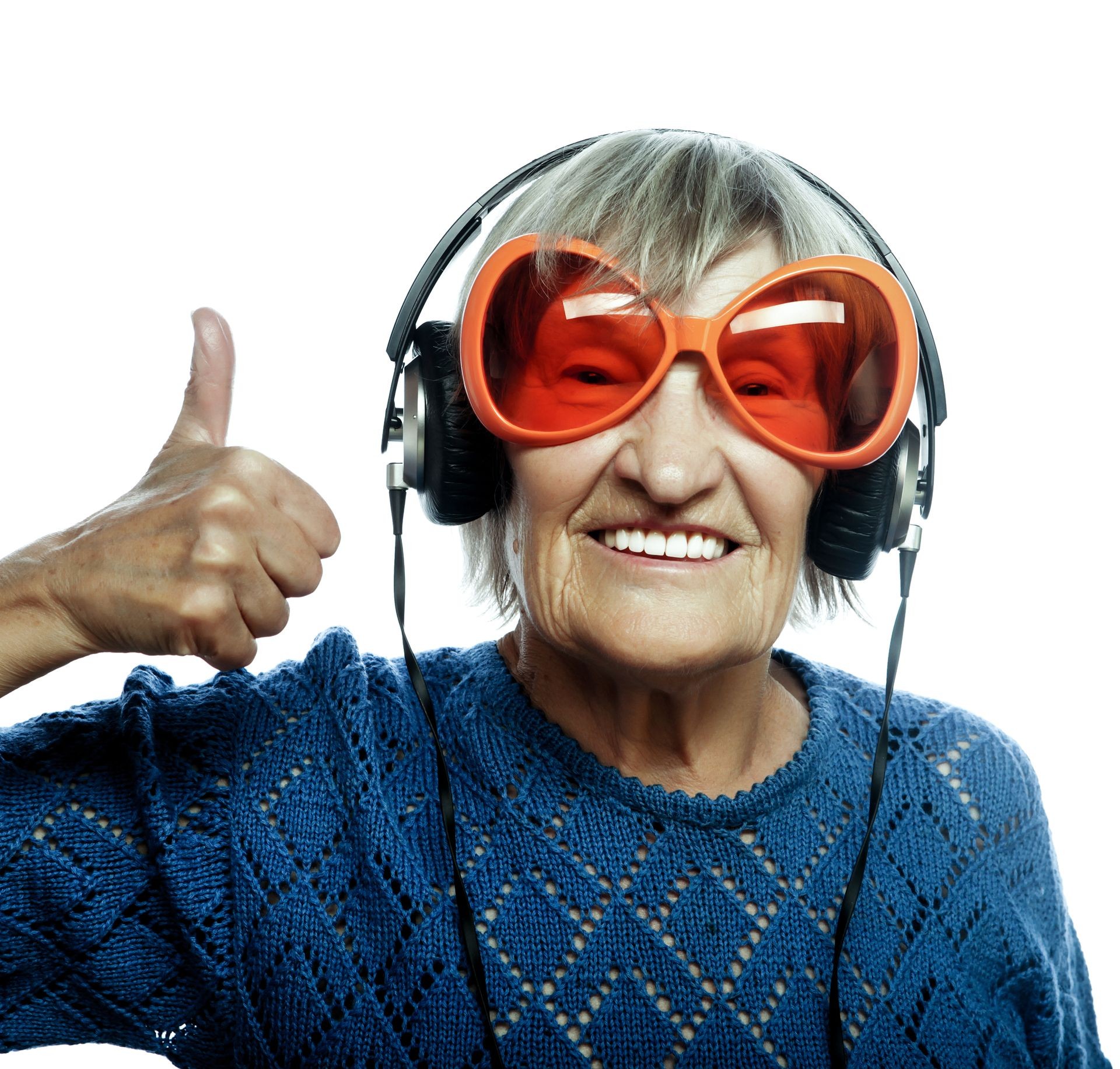 Funny old lady listening music and showing thumbs up. Isolated on white.