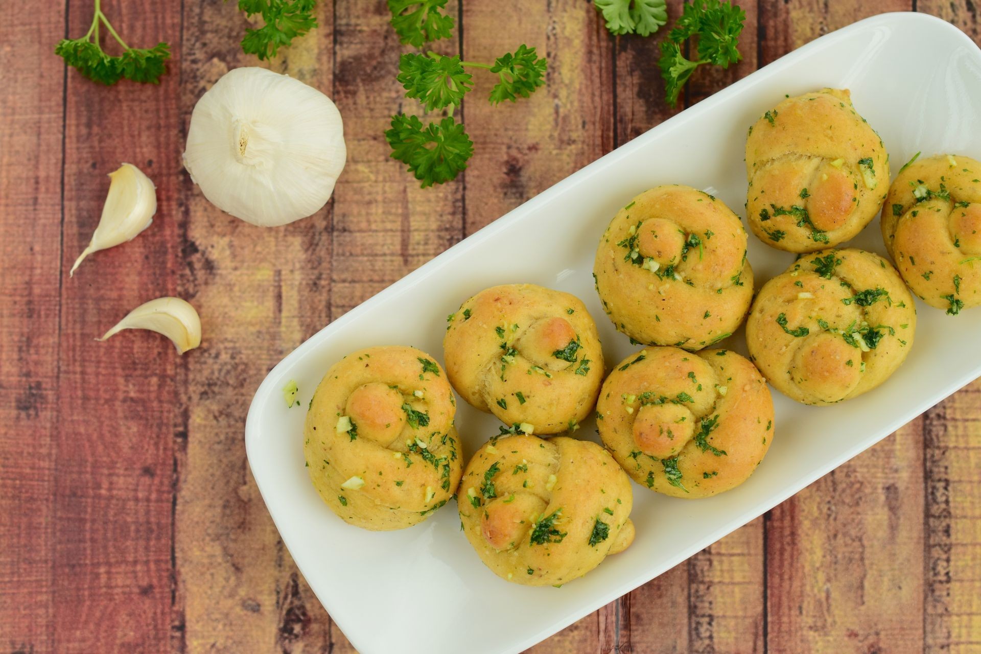 Garlic knots with coated with garlic parsley butter