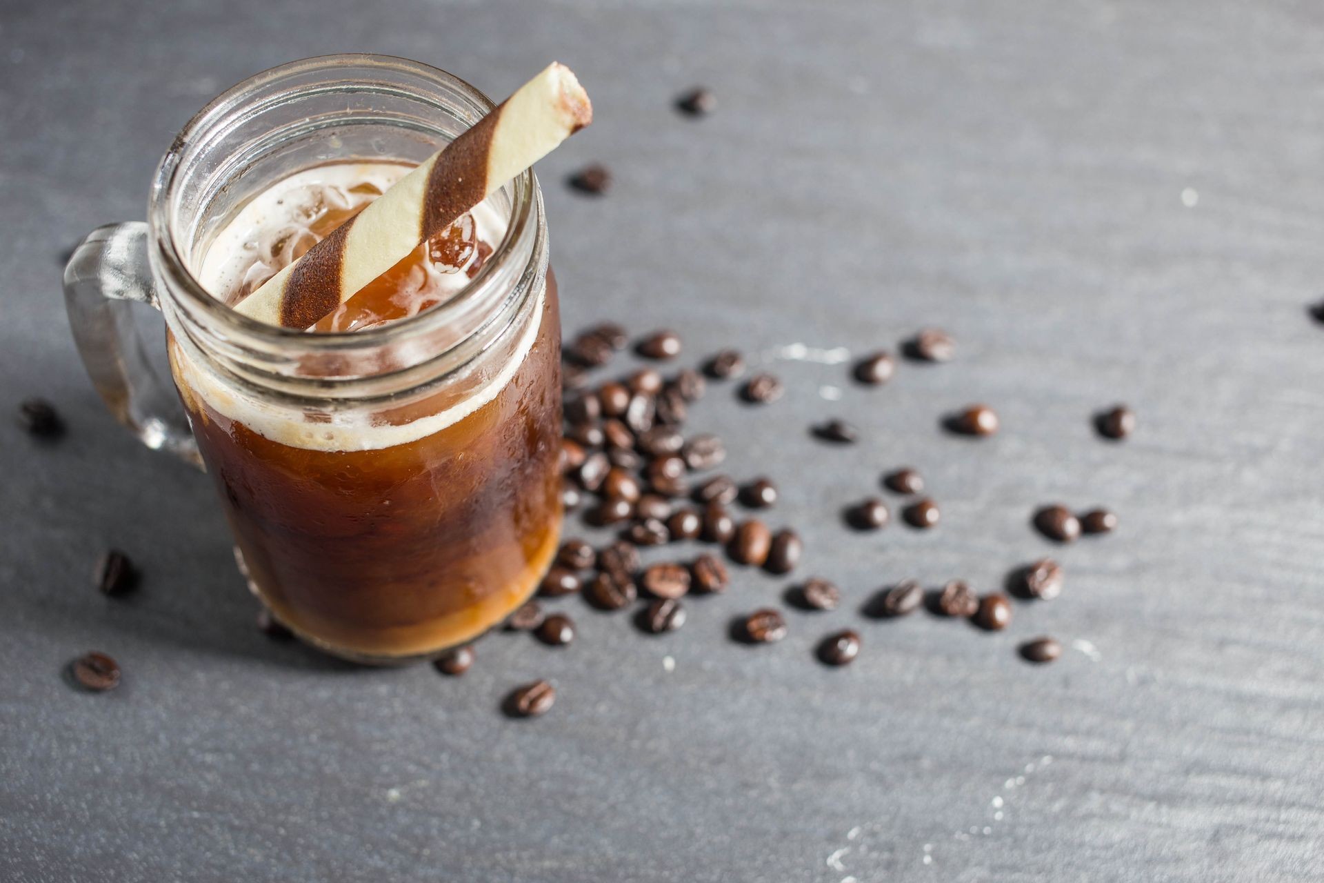 Coffee and coffee bean on the black table.