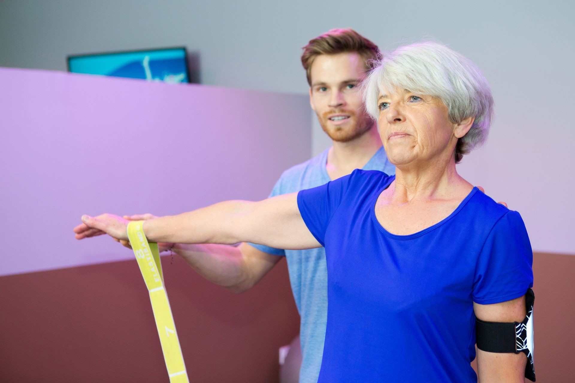 sport coach training senior woman with stretching exercises