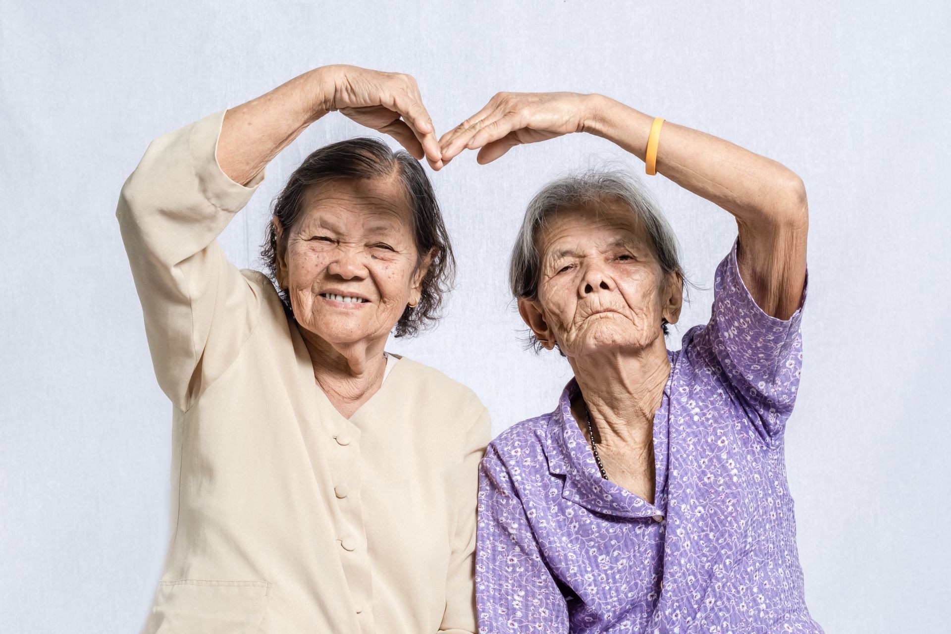 Portrait of senior woman making the sign of love, 