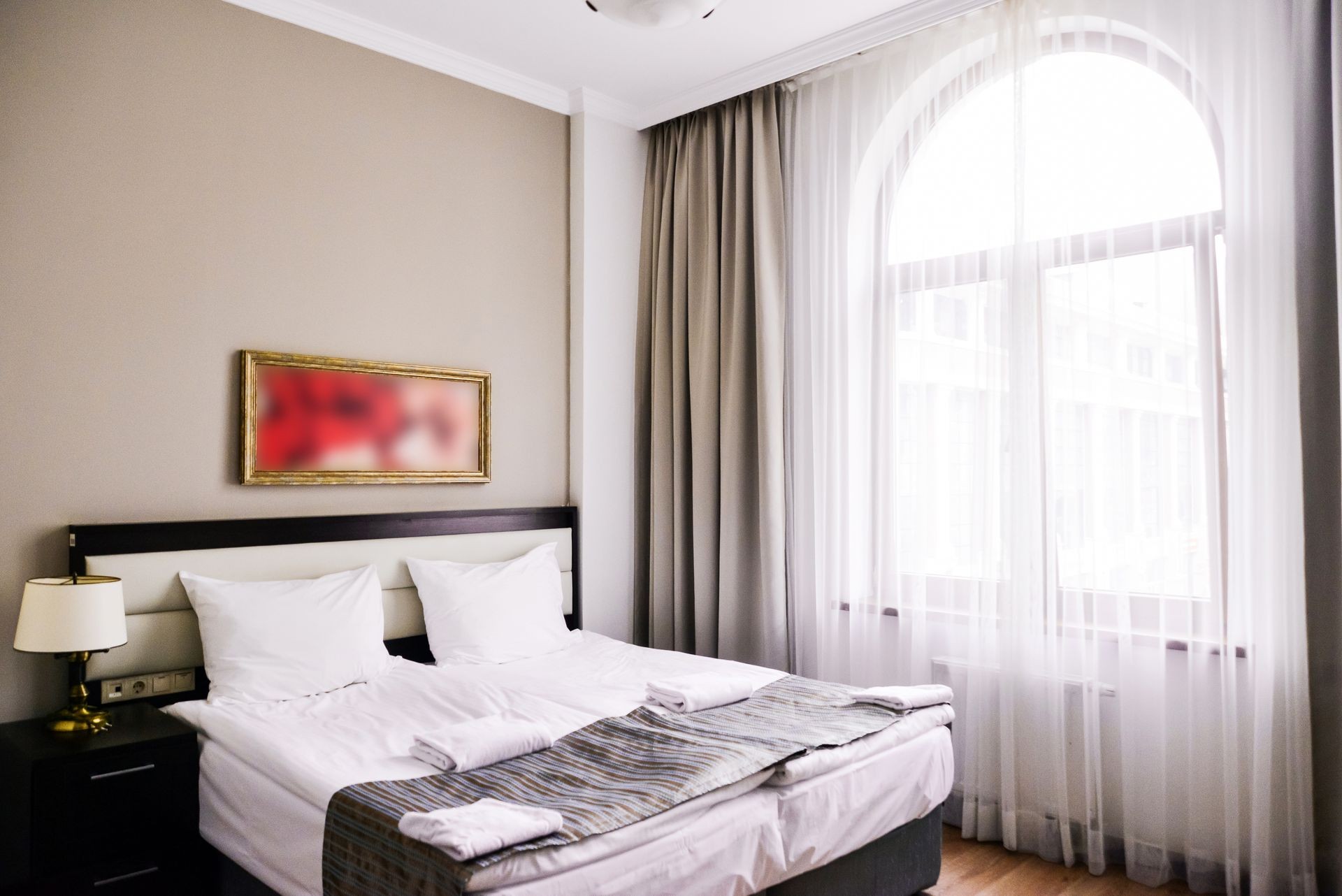 Bedroom interior in light and sand tones, bed and window