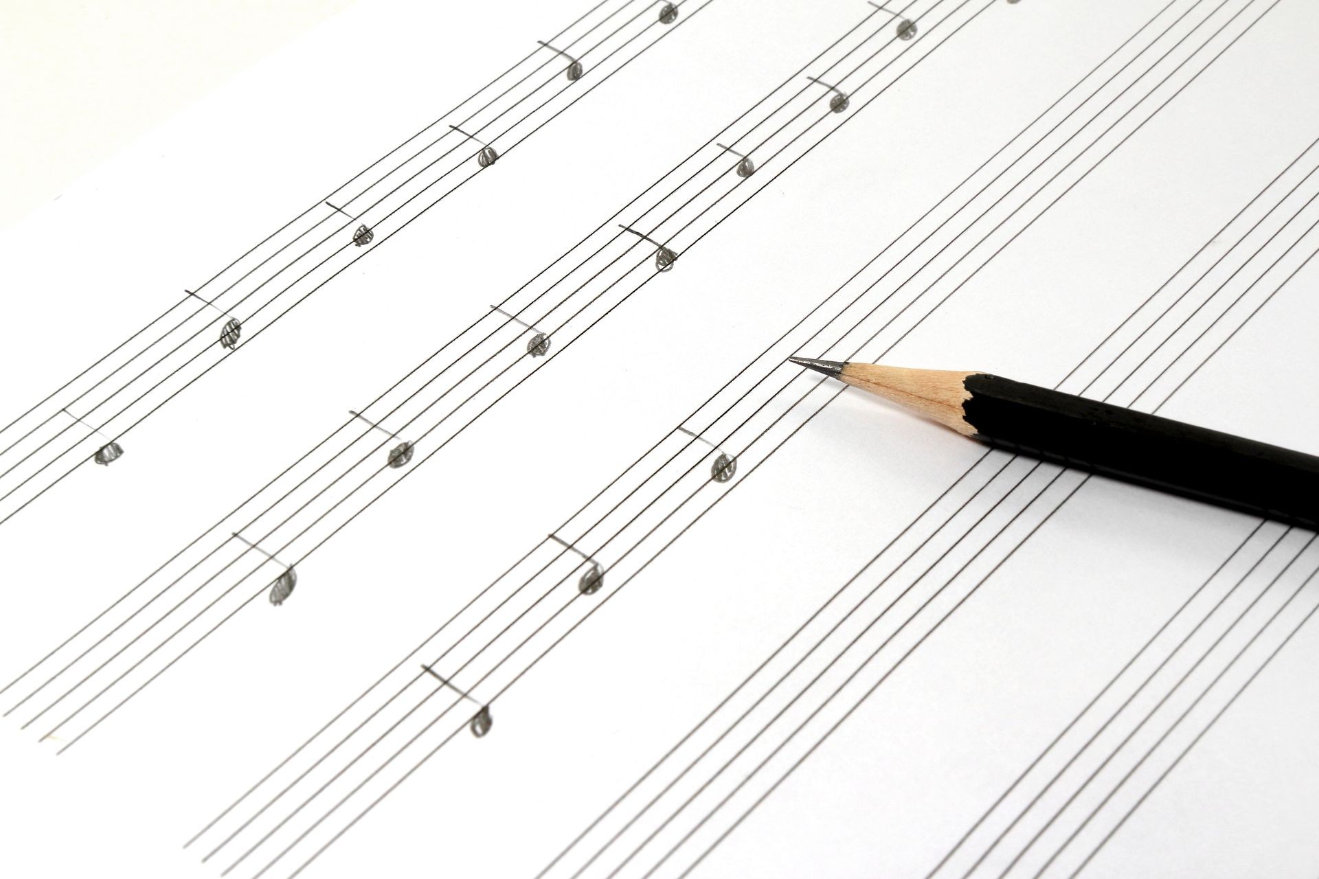 Music sheet and handwritten musical notes with black pencil.